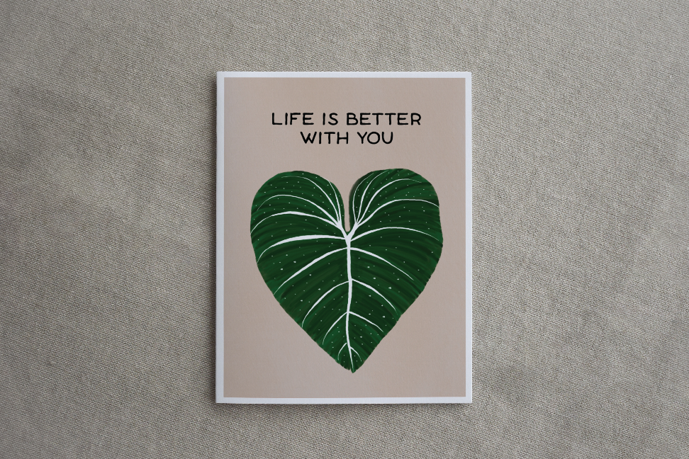 Framed-style printed card with green leaf-heart and "LIFE IS BETTER WITH YOU"