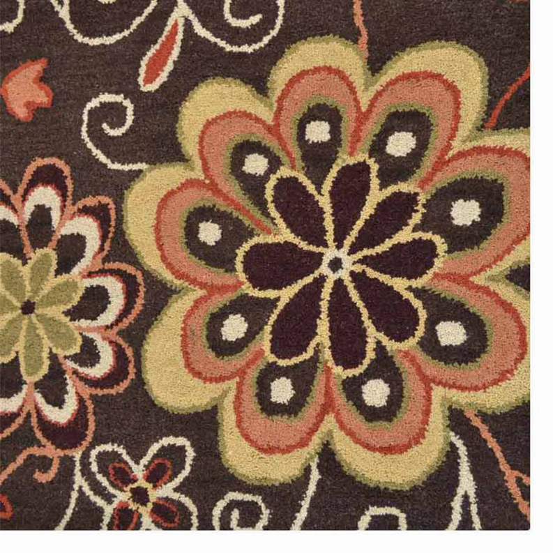 Close-up of multicolor flower motif on dark brown floral area rug with scrollwork
