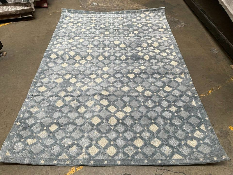 Blue geometric handmade area rug with all-over diamond pattern on large flat pile