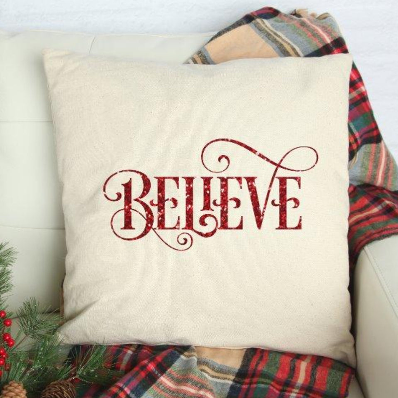 Believe decorative pillow cover with red embroidered "BELIEVE" on cream fabric