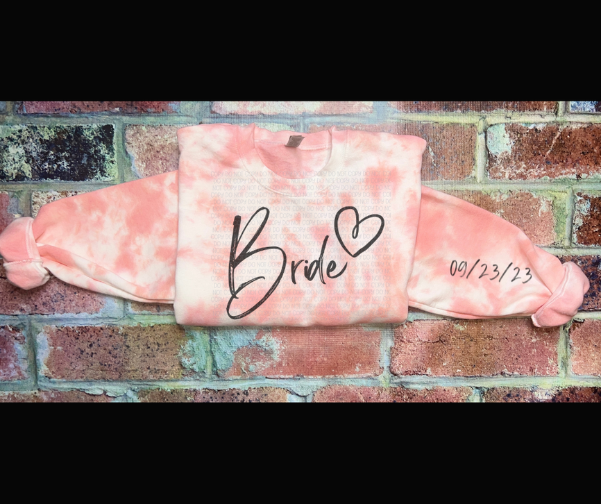 Pink tie-dye crewneck sweatshirt with 'Bride' graphic and date on right sleeve
