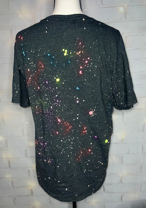 Black reverse tie-dye blank tee back view with multicolor speckled spray splatter
