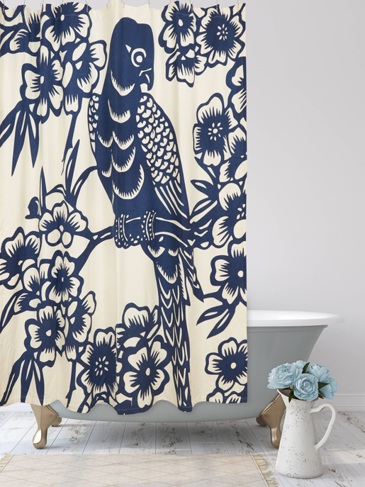 Hanging shower curtain panel with navy parrot and flowers on off-white background.
