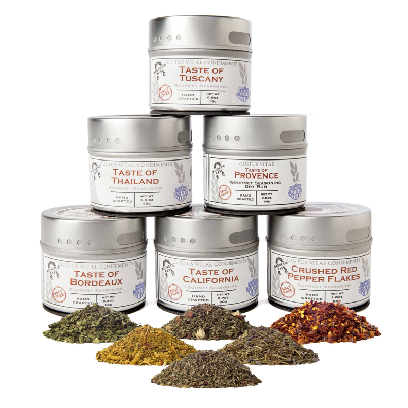 Set of six salt-free seasoning tins with assorted dried herb blends in front