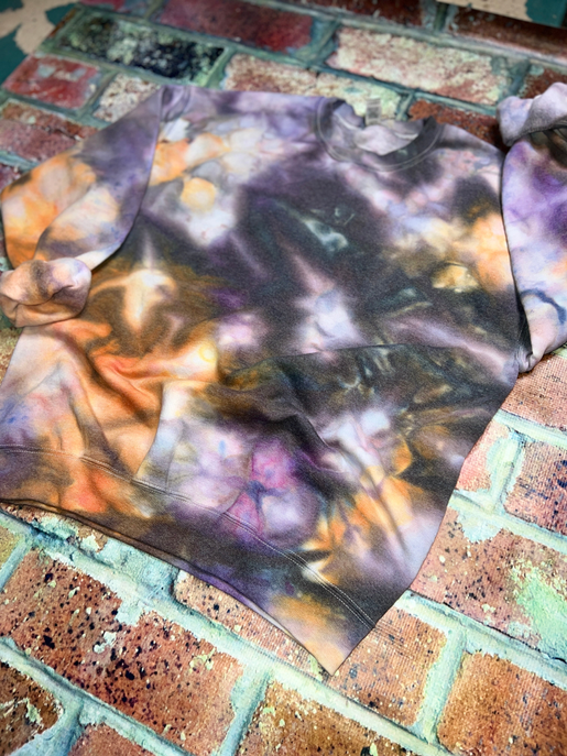 Tie-dye crewneck sweatshirt in purple, orange, and dark tones, crew neck and long sleeves