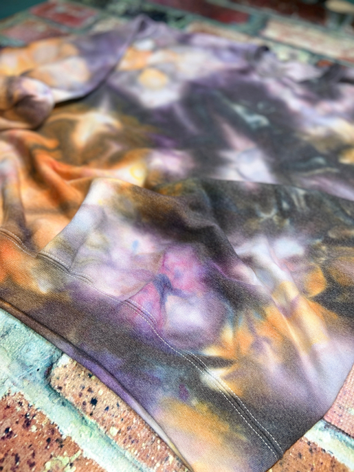 Close-up of ice tie-dye sweatshirt hem and cuffs, purple and orange swirl