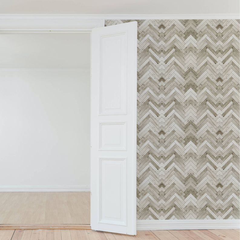 Woodgrain herringbone peel-and-stick wallpaper panel in light gray and white