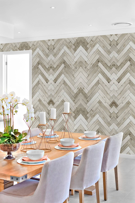 Light gray and white herringbone woodgrain peel-and-stick wallpaper on wall