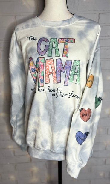 Light blue tie-dye sweatshirt with 'CAT MOM' text and paw print heart sleeve