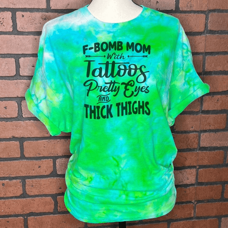 Aqua and green tie-dye graphic T-shirt with F-BOMB MOM tattoo-style text