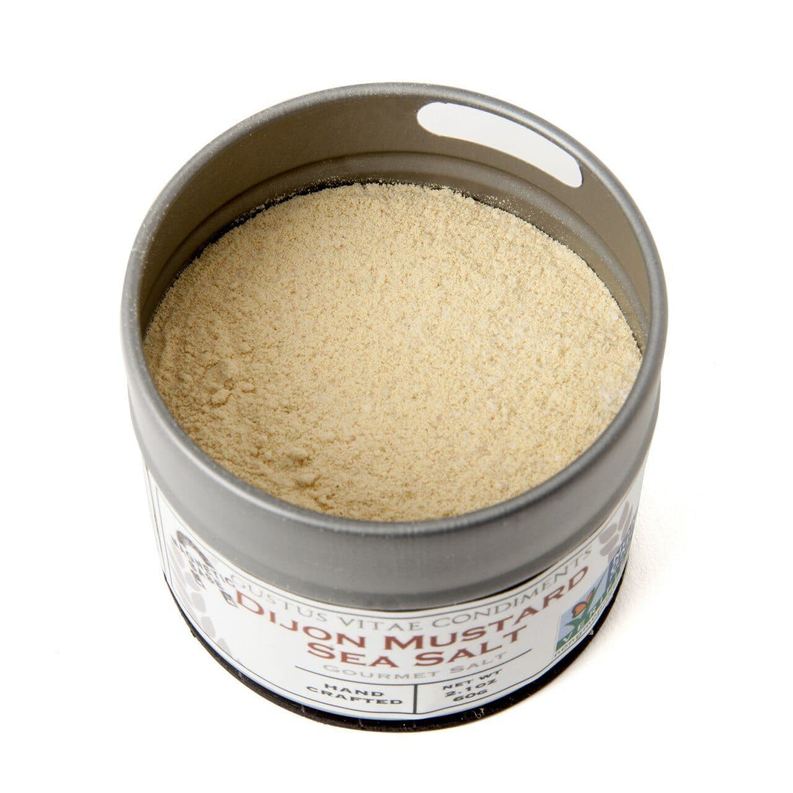 Round metal tin of gourmet sea salt with light beige granules inside