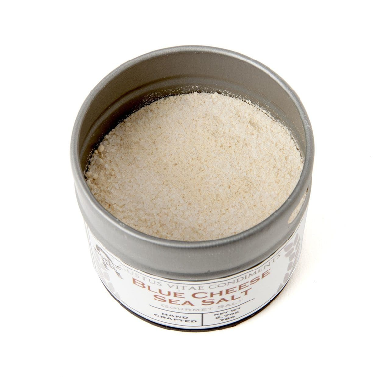 Round metal tin of gourmet sea salt with pale cream granules inside