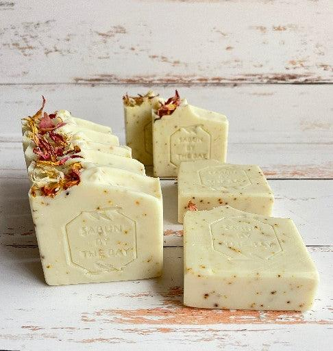 Ivory soap bars with embossed stamps and herb bits, stacked in multiple views