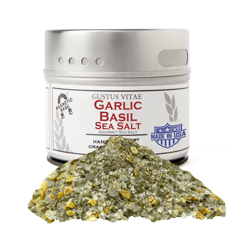 Garlic basil sea salt jar with silver lid and green herb salt pile