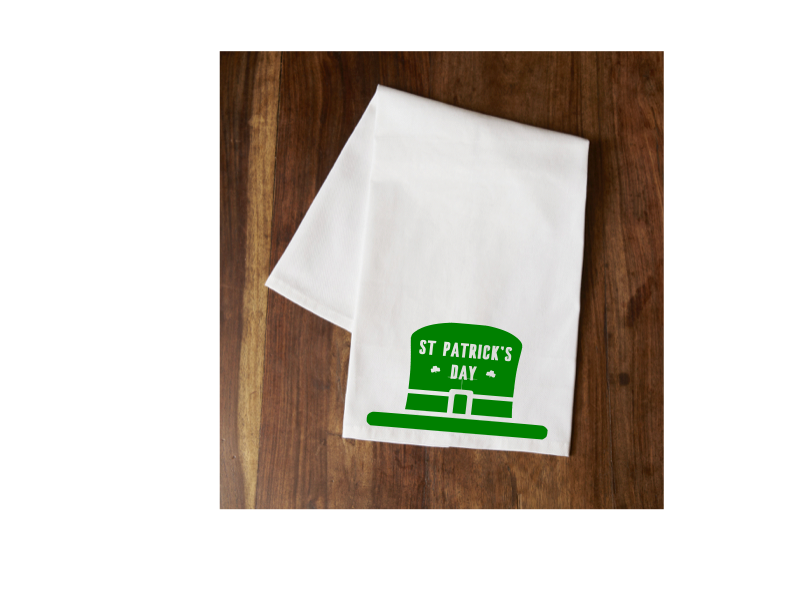 White tea towel with green St. Patrick's Day text and hat graphic