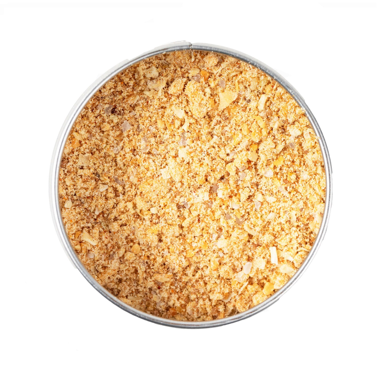 Bowl of pineapple BBQ rub seasoning with coarse golden-brown spice