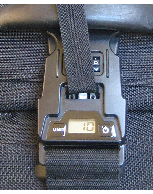 Luggage belt with built-in scale display and black locking clasp on a suitcase handle