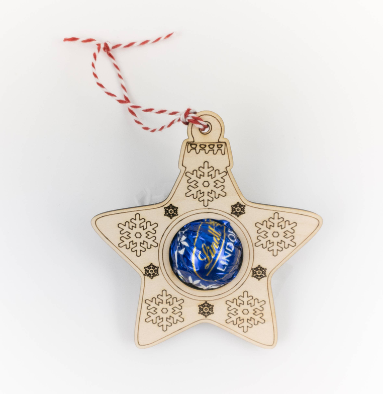 Star-shaped truffle candy holder ornament with gold snowflake pattern and red-and-white twine