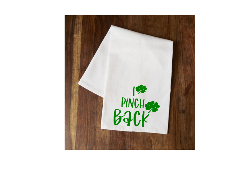 White tea towel with green Pinch Back text and clover print