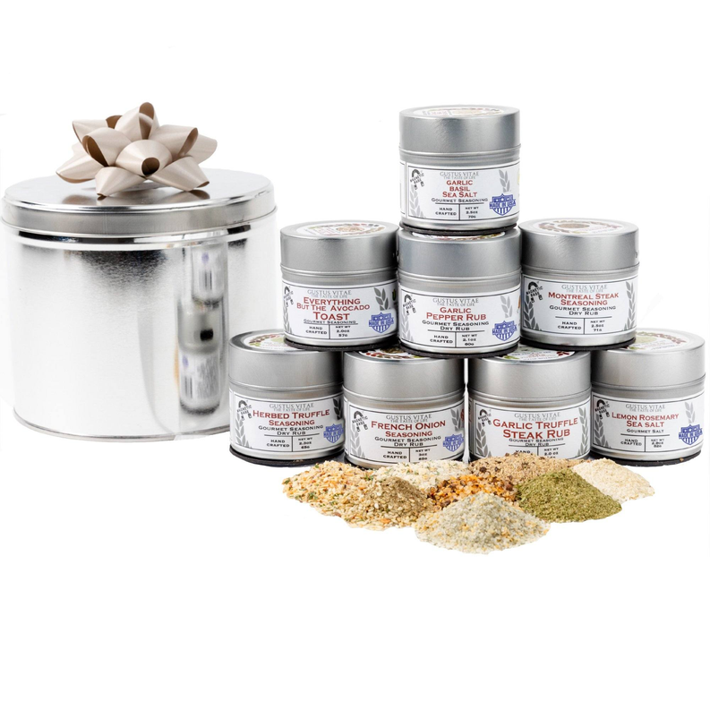 Gourmet seasoning gift tin set with multiple labeled spice containers and seasoning piles