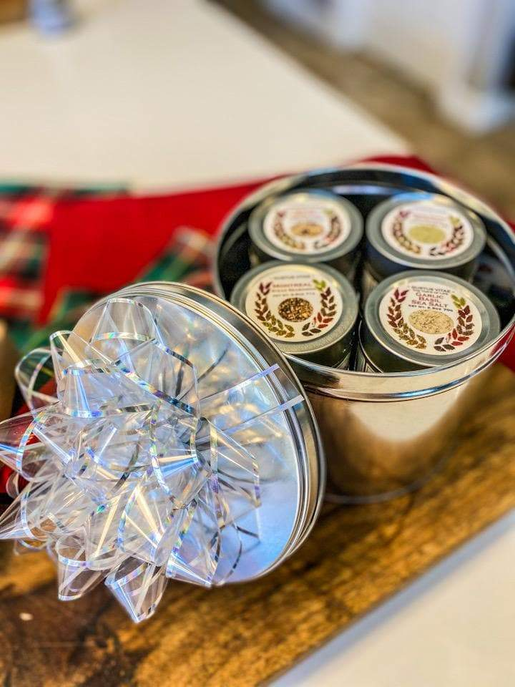 Gourmet seasoning gift tin with hinged lid and several small spice tins with labels