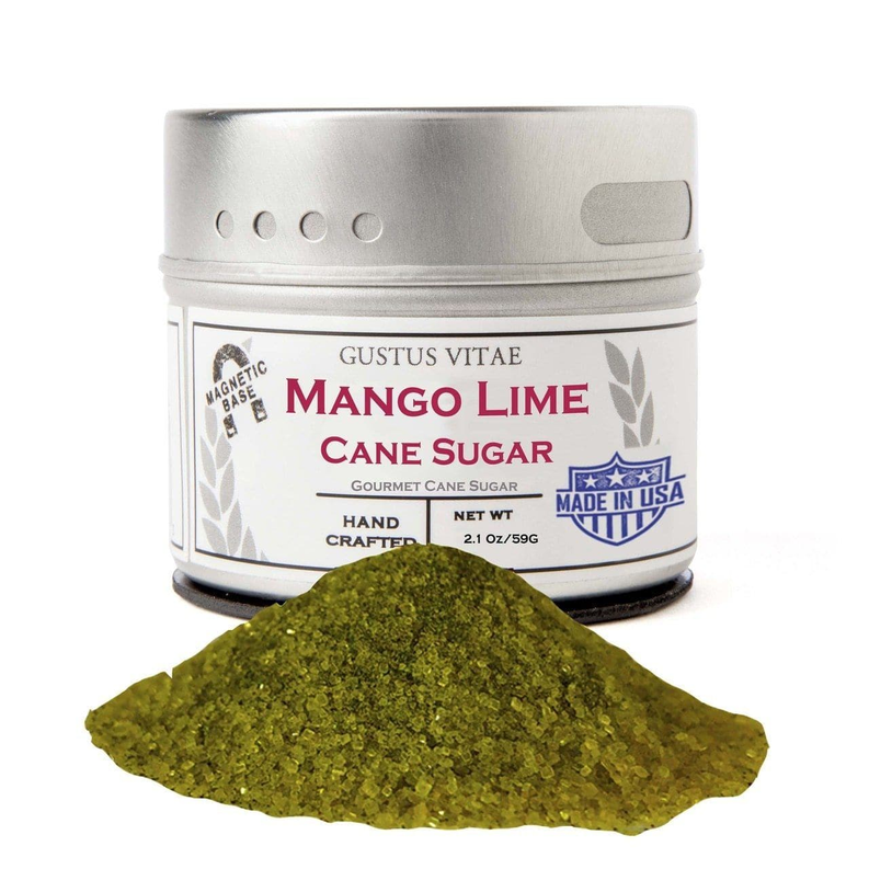 Mango lime cane sugar tin with mound of green sugar granules in front.