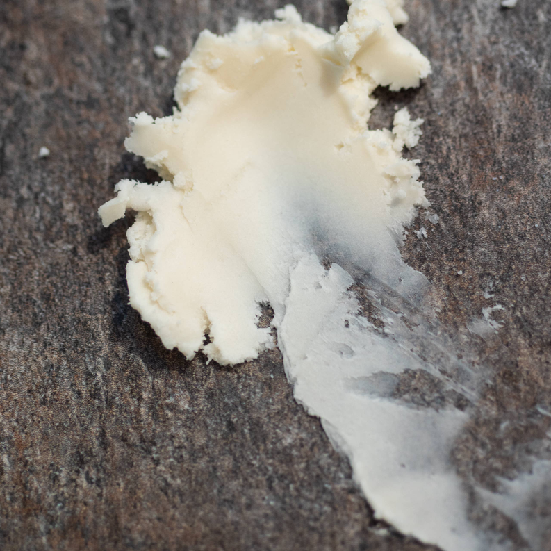Off-white mango butter chunks in a pile