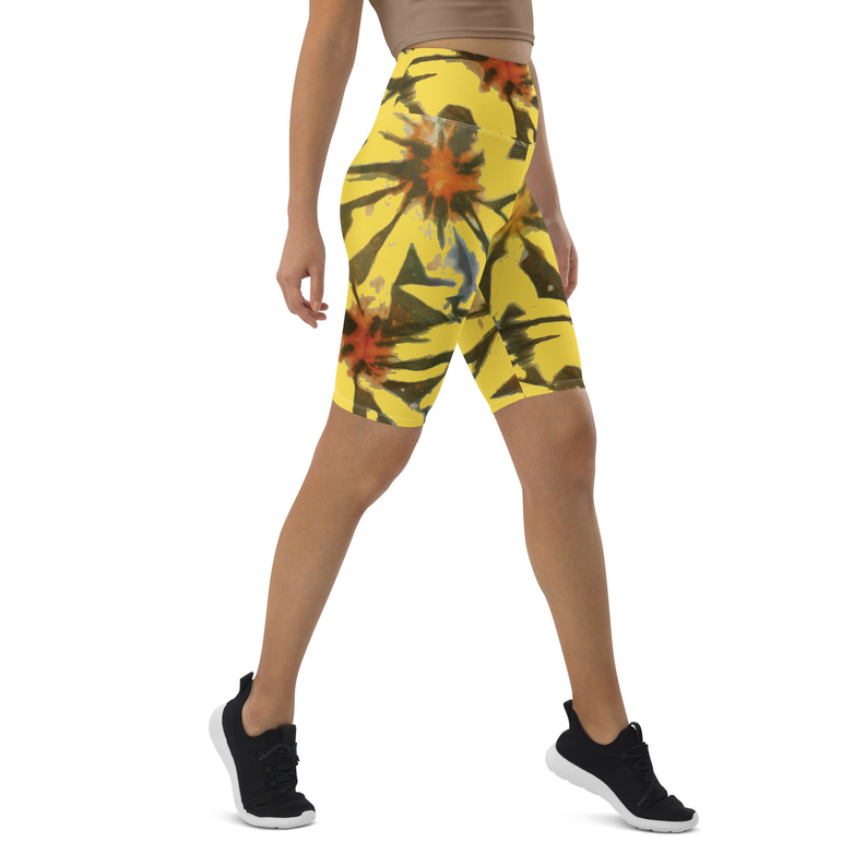 Yellow tie-dye biker shorts, mid-thigh length, front view with legs