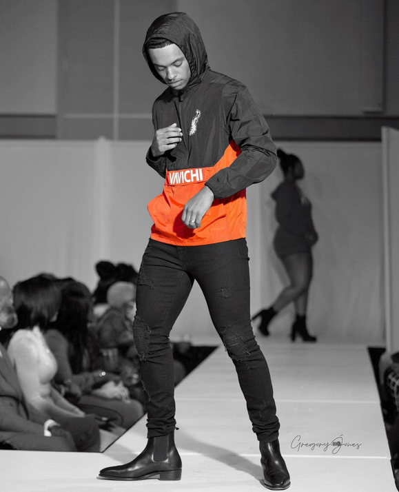 Hooded lightweight jacket with black hood and orange front panel, white logo detail