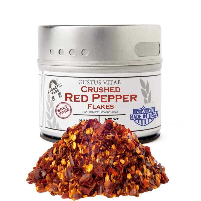 Crushed red pepper flakes tin with metal lid and pile of red pepper flakes