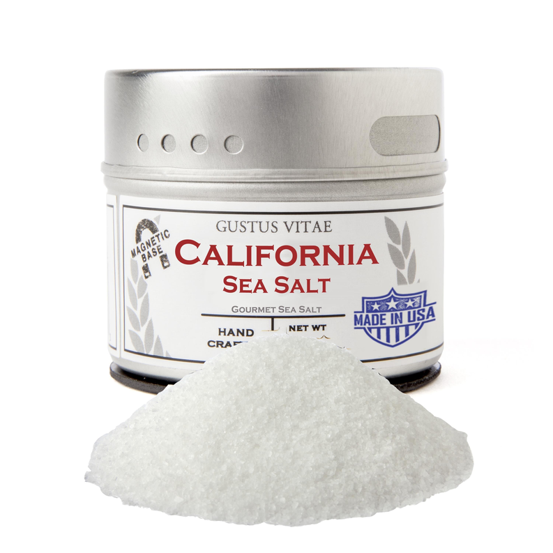Sea salt jar with silver lid and label, with a small mound of white salt in front