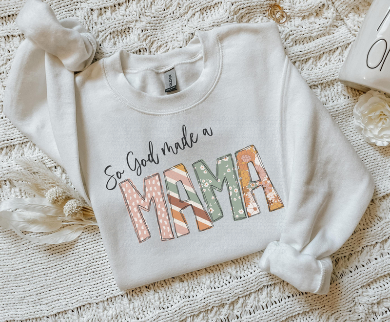 Cream crewneck sweatshirt with long sleeves and graphic "So God made a mama" print
