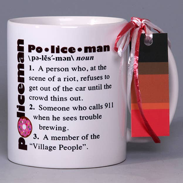 White mug with whimsical policeman text, donut logo, and red bow tied to handle