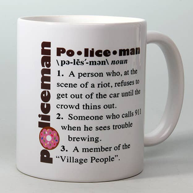 White mug with Po·lice·man lettering and colorful donut icon on front