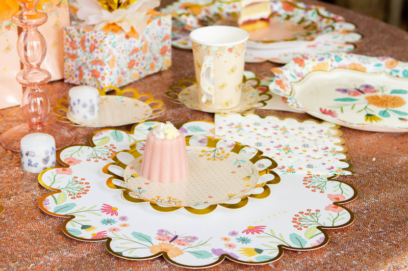 Scalloped round floral paper placemat with butterfly and flower bouquet pattern