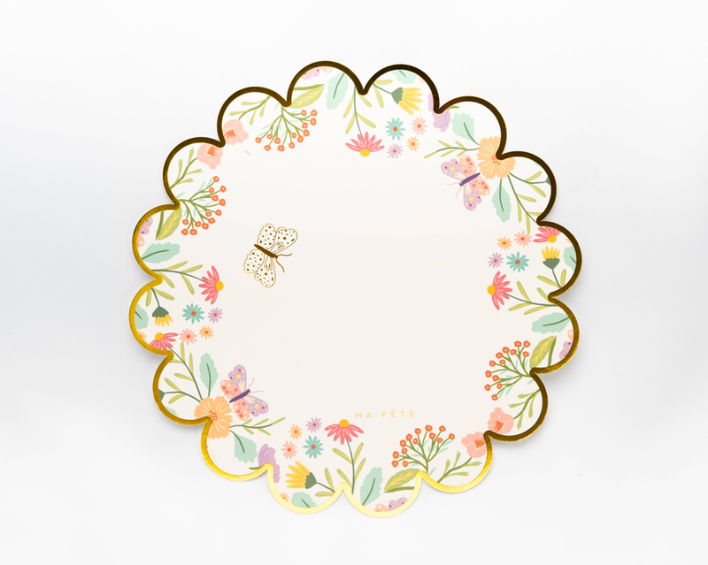 Floral round scalloped paper placemat with butterfly, greenery, and pastel blooms border