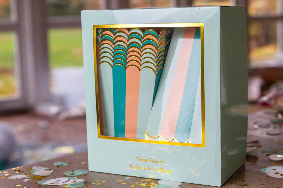 Square treat box with gold frame window and teal/peach/green striped insert