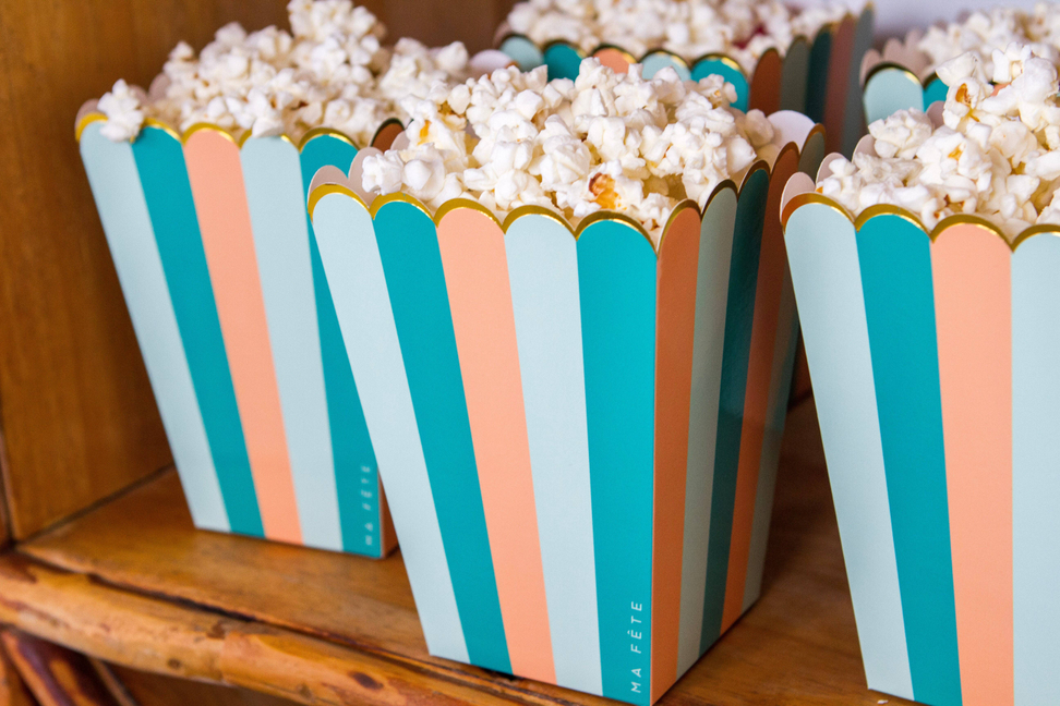 Fun fair treat holder, teal/peach/green stripes, filled with white popcorn