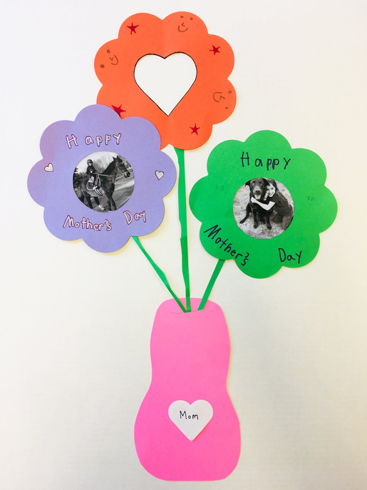 Colorful flower cut-outs on sticks with heart photos for Mother's Day