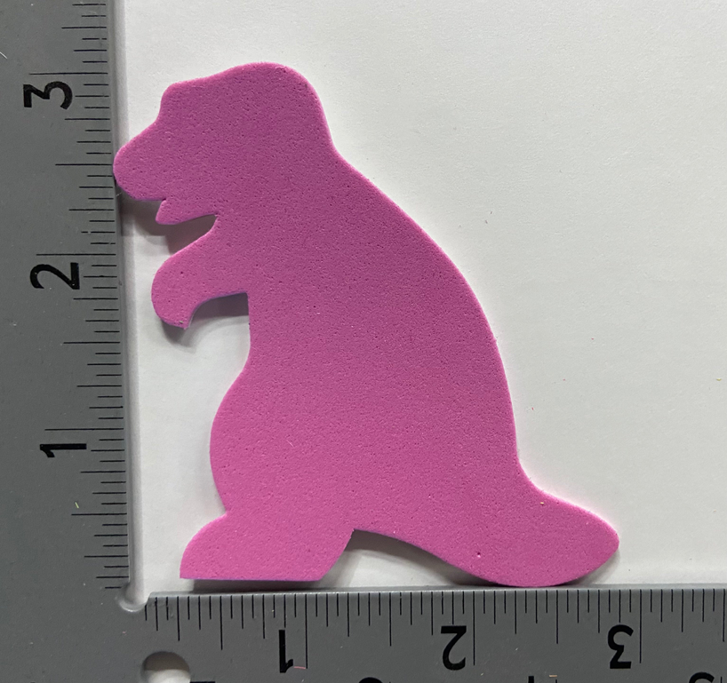 Purple foam animal cut-out on paper next to measuring ruler