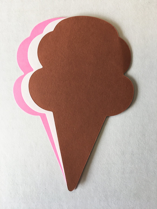 Brown ice cream cone paper cut-out with pink and white layered scalloped edges