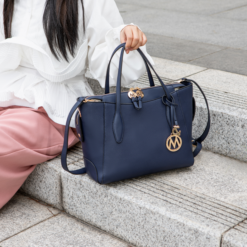 Dark vegan leather tote bag with top handles and matching wallet, front charm logo