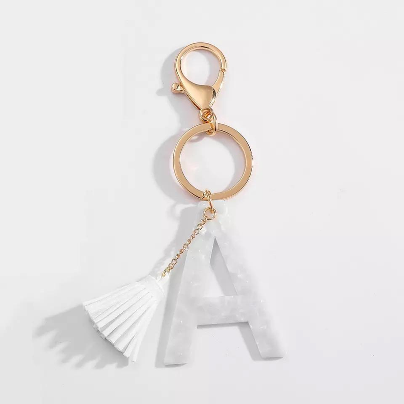 White tassel initial key chain with gold ring and letter A charm