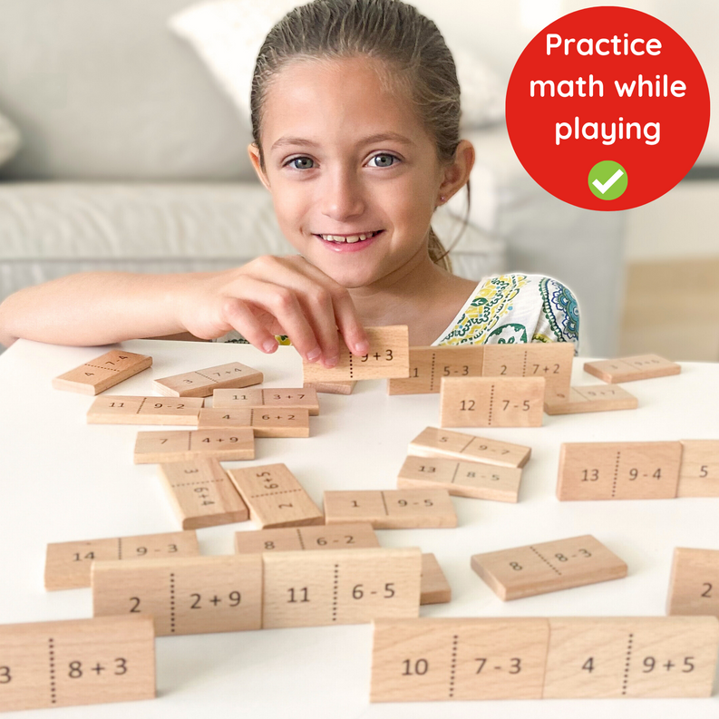 Wooden Math domino tiles with printed numbers and dotted divider lines on a tabletop.