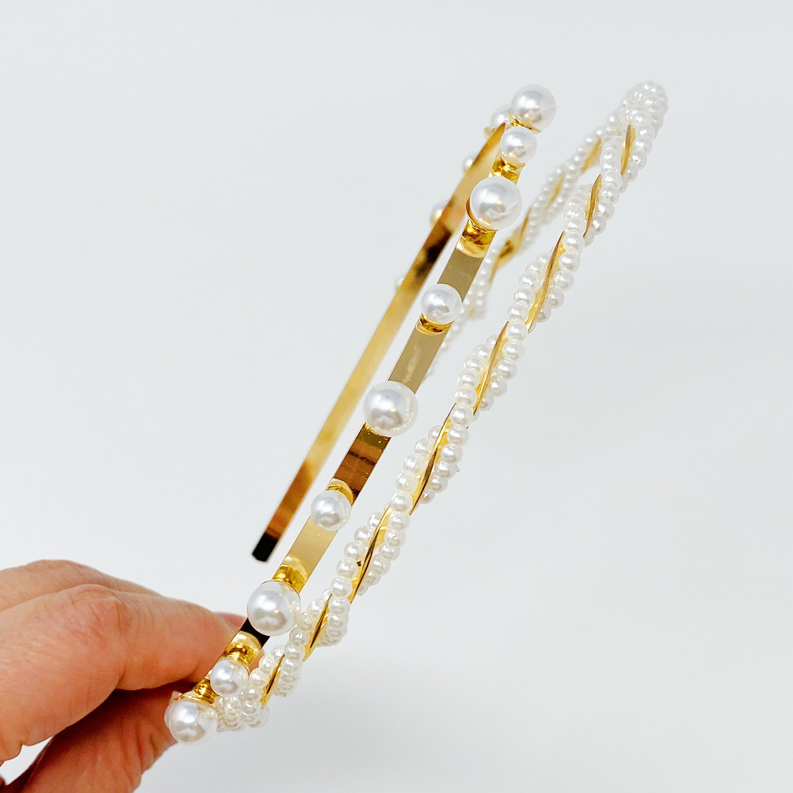 Pearl headband close-up held in hand, gold stripe accents with white pearl beads