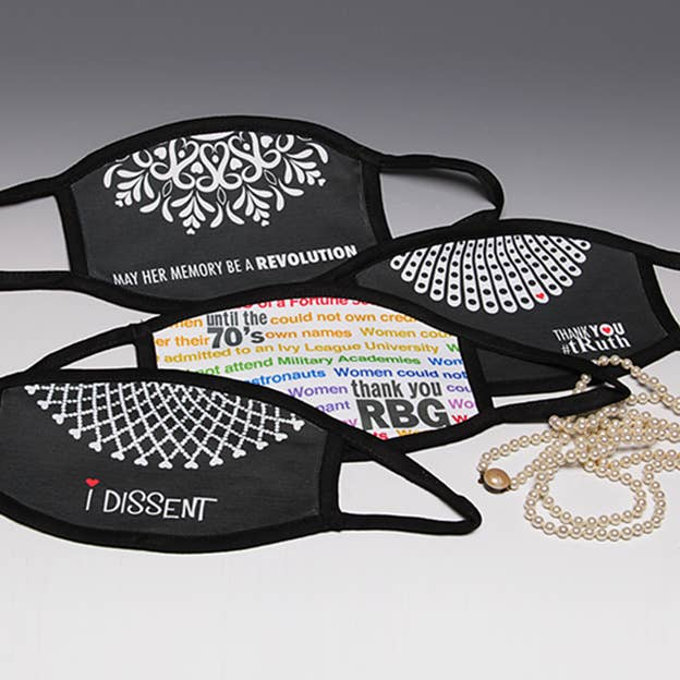 Black face masks set with white text "I DISSENT" and patterned fronts, ear loops