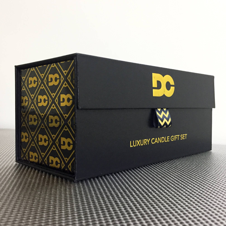 Luxury candle gift set box with DC logo, black and gold patterned sleeve