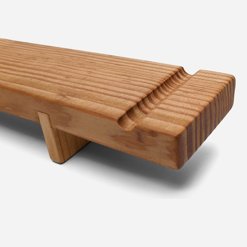 Wood charcuterie board with center groove and notched side details.