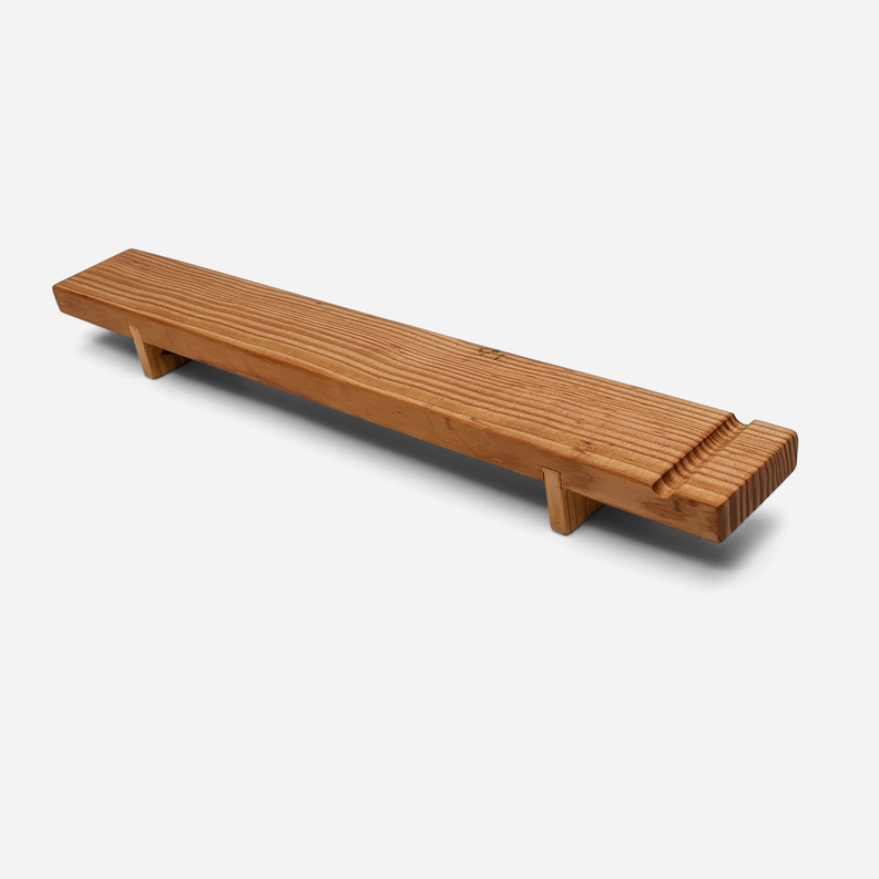 Wood charcuterie board with long serving surface and built-in end rests.