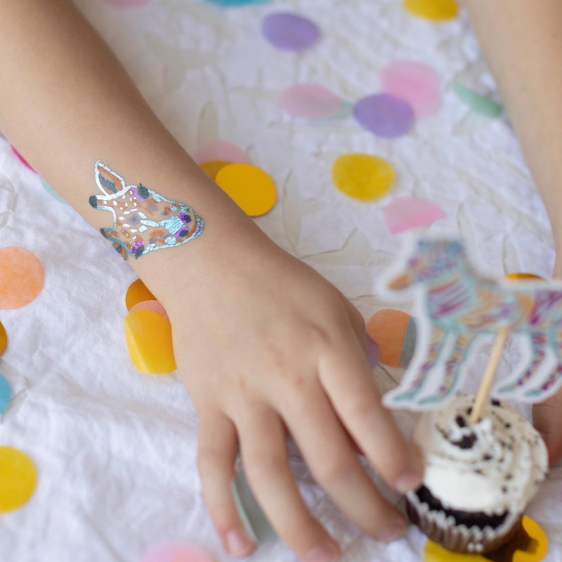 Safari temporary tattoo on child's arm with a colorful lion-head and mane design